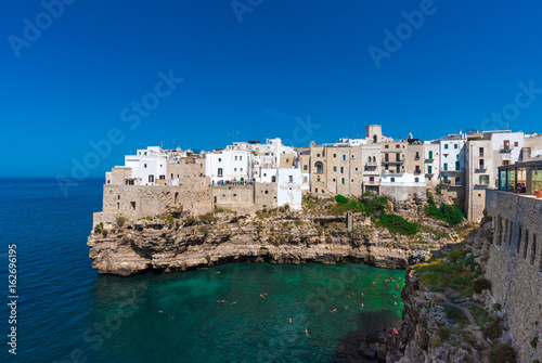 Fototapeta Naklejka Na Ścianę i Meble -  Polignano a Mare (Puglia, Italy) - The famous sea town in province of Bari, southern Italy. The village rises on rocky spur over the Adriatic Sea, and is known tourist attraction.
