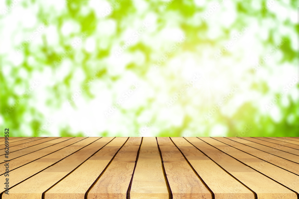 Perspective wooden table on top over blur coffee shop background, can be used mock up for montage products display or design layout.
