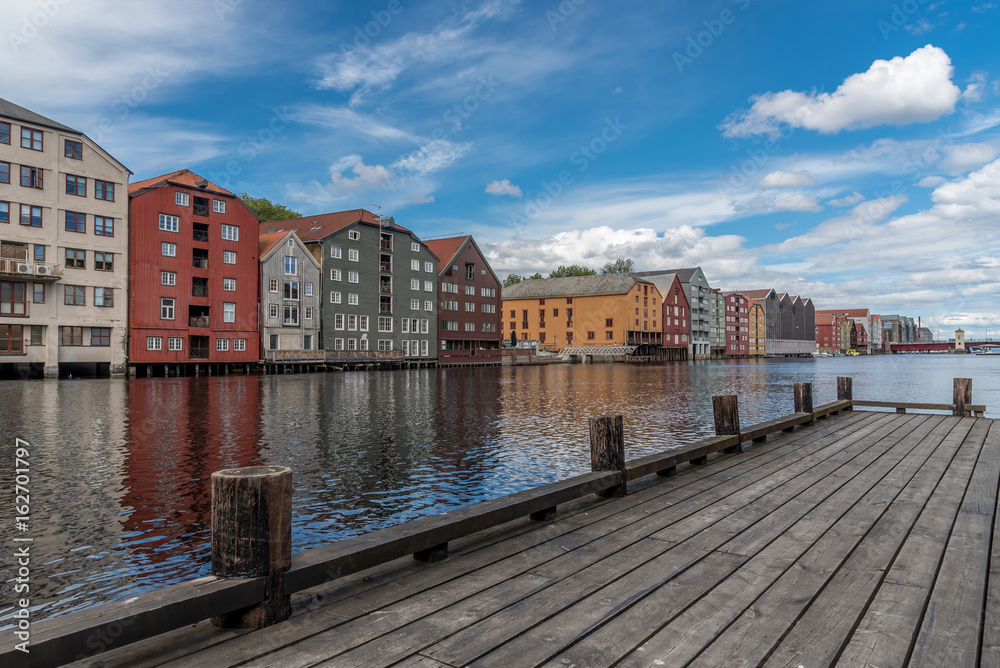 Traditional fisherman wharf with old storehouses along the river Nidelven. Trondheim, Norway.