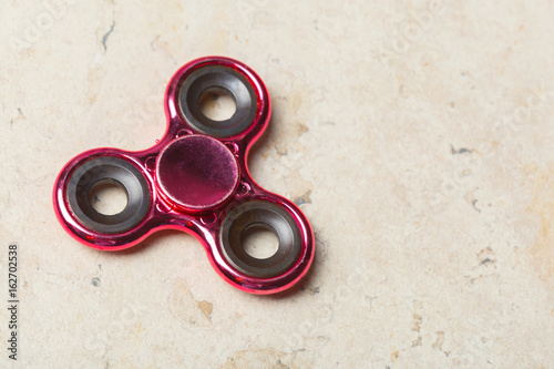 fidget SPINNER stress relieving toy on stone background