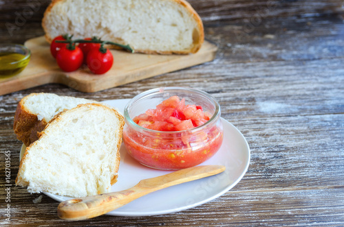 Pa amb tomaquet  or  pa amb tomaca (bread with tomato) is a popular snack of Catalan cuisine. Close up of typical tapa in Catalonia,Spain. photo