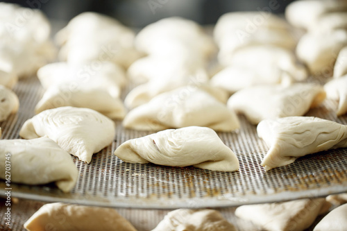 billet bun of dough with filling inside. Prepared for baking in baking production.