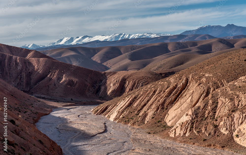 View of High Atlas mountains with dry river bed, Gorges de Dades, Morocco