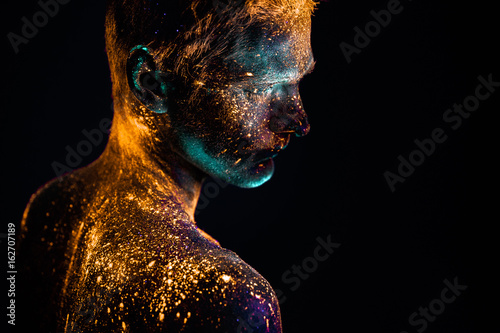 Portrait of a man painted in fluorescent UV colors.