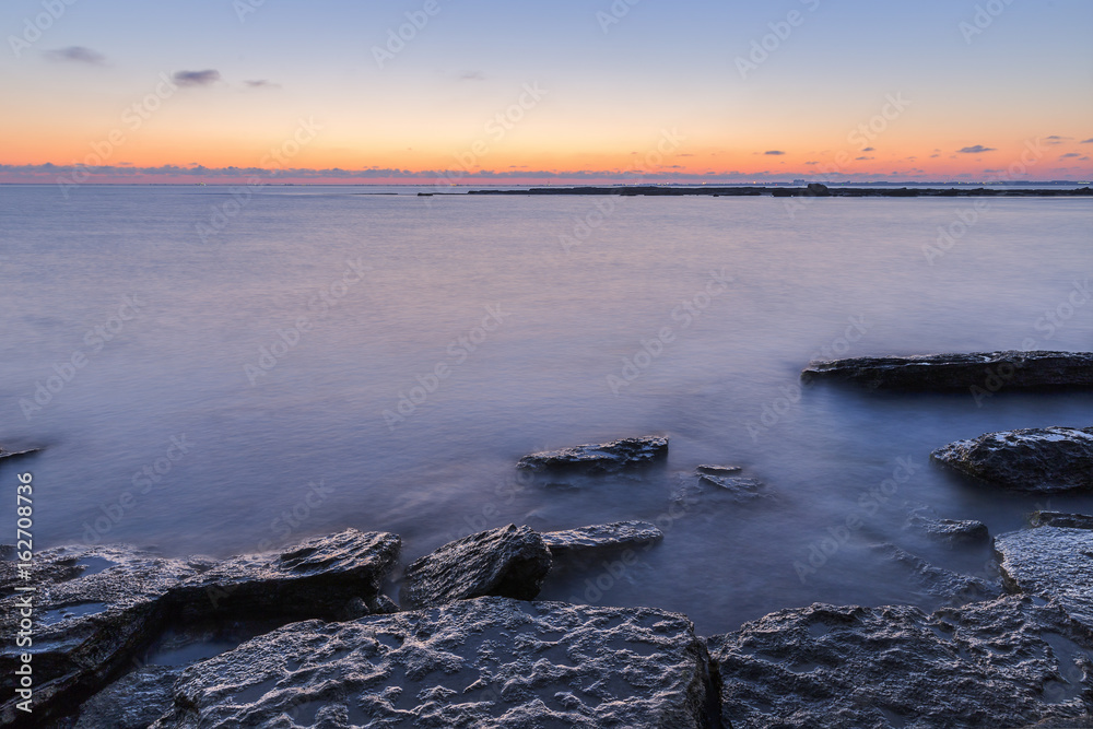 Fototapeta premium Sunrise on the wild beach of the Caspian Sea coast near Baku