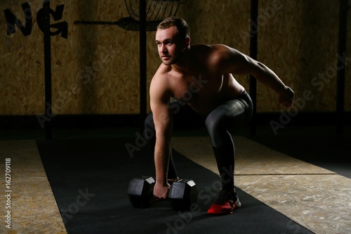 Full body of sportsman exercising with dumbbells