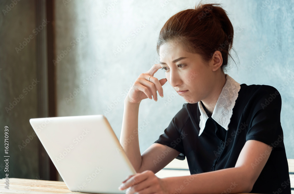 Beautiful asian woman working with computer in the room. Beautiful asian woman working with computer in the room.