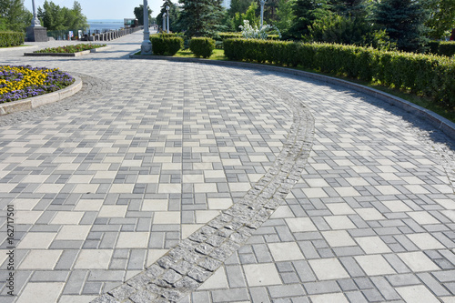 A path of gray paving slabs on the waterfront