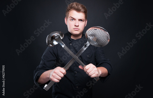 Picture with professional chef holding ladle and skimmer