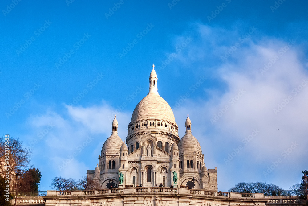 The Basilica Sacre Couer in Paris, France on a mostly clear day