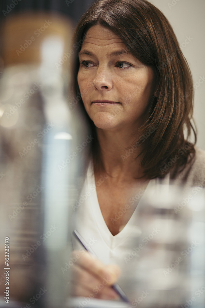 Low angle view of thoughtful businesswoman looking away at office Low angle view of thoughtful businesswoman looking away at office