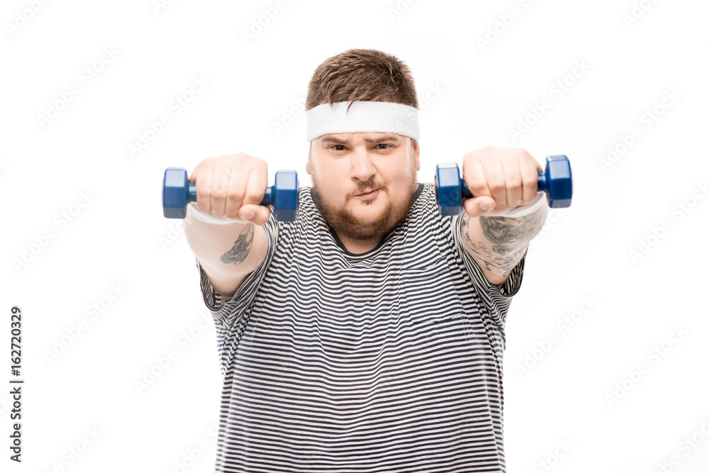 portrait of chubby man exercising with dumbbells and looking at camera isolated on white portrait of chubby man exercising with dumbbells and looking at camera isolated on white