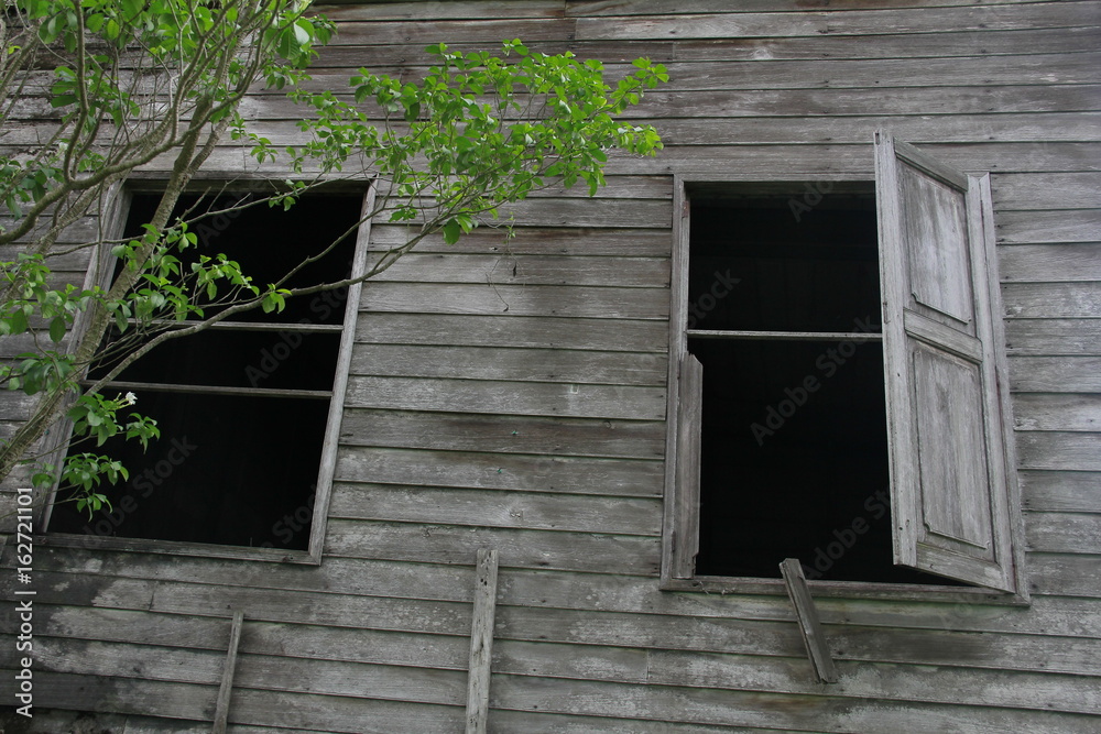 Ancient wooden house architecture Gray is in the garden with green trees surrounded by nature. Ancient wooden house architecture Gray is in the garden with green trees surrounded by nature.