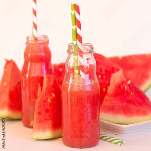 Fresh Color Juices Smoothie Fruits Watermelon Bottles On a White background, square