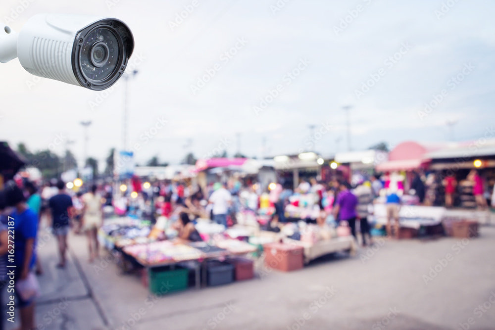 Obraz premium security CCTV camera or surveillance system with blurred market background
