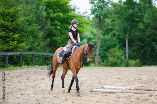 Horse rider is training in the arena © castenoid