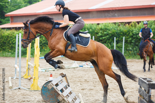 Horse rider is training in the arena