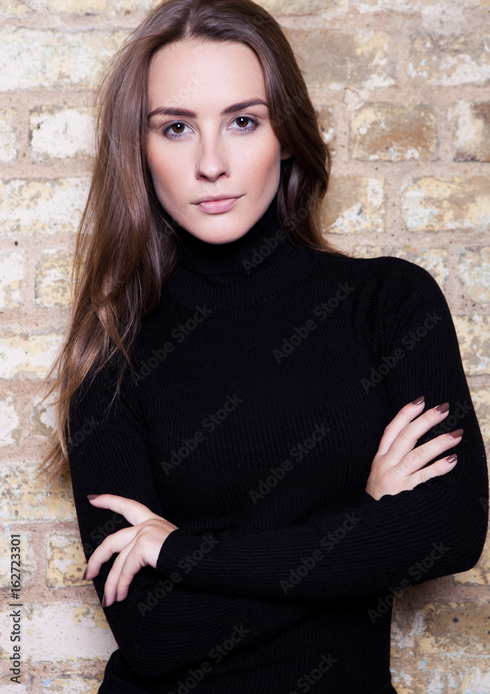 Fashion model posing next to yellow brick wall Fashion model posing next to yellow brick wall