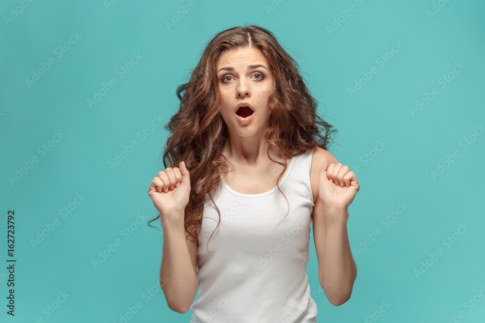 Portrait of young woman with shocked facial expression