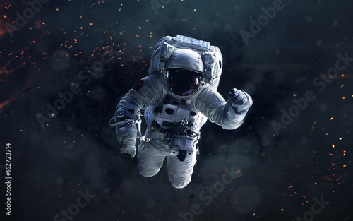 Science fiction space wallpaper with astronaut, incredibly beautiful planets, galaxies, dark and cold beauty of endless universe. Elements of this image furnished by NASA
