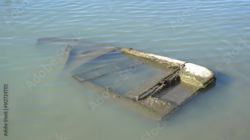 4K Old sunken boat in muddy water photo