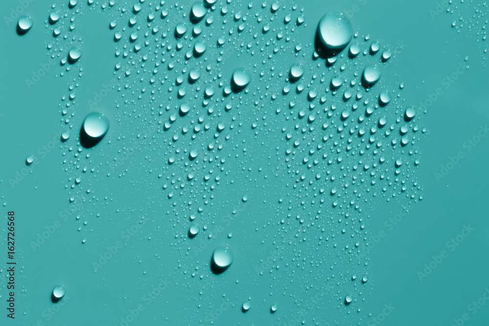 Water drops on smooth surface, blue green background