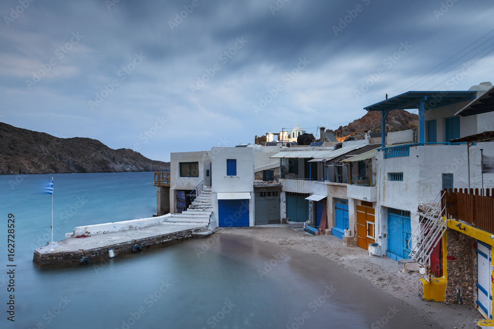 View of boat houses in Firopotamos fishing village on Milos island in Greece.
