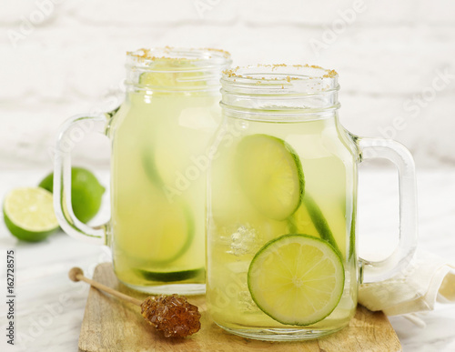 Konstfotografi Fresh lime drink with brown sugar