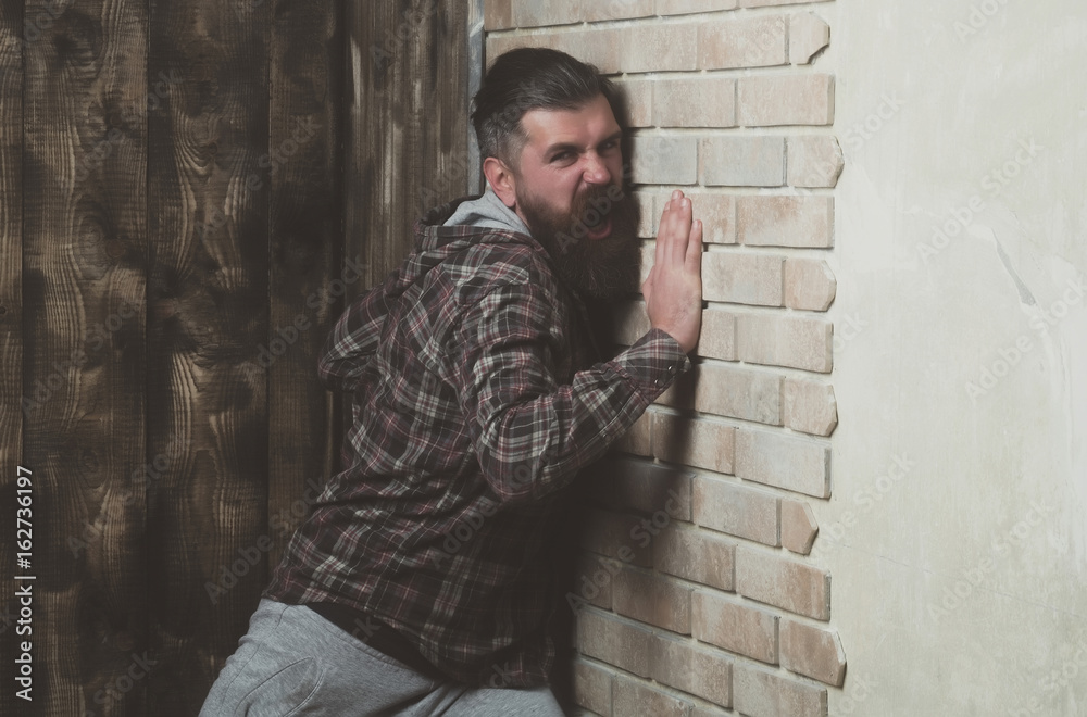 hipster screaming at brick wall