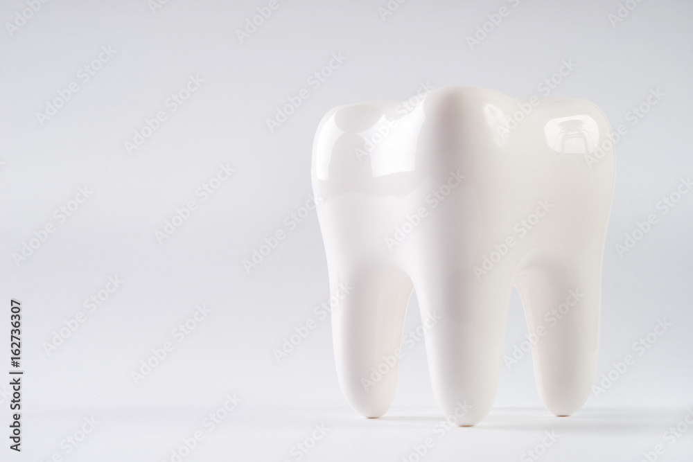 White healthy Tooth isolated on white background with copy space. Oral dental hygiene. Teeth Whitening. Dental health Concept. Oral Care, teeth restoration. Yellow and white teeth. White healthy Tooth isolated on white background with copy space. Oral dental hygiene. Teeth Whitening. Dental health Concept. Oral Care, teeth restoration. Yellow and white teeth.