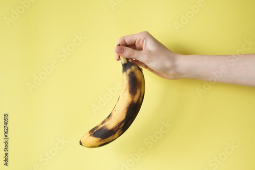 Human Hand Holding Banana Fruit Nutrition Concept photo