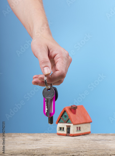 mortgage, investment, real estate and property concept - close up of home model, money and house keys