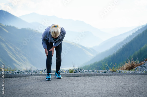 Injuries - sports running knee injury on woman. photo