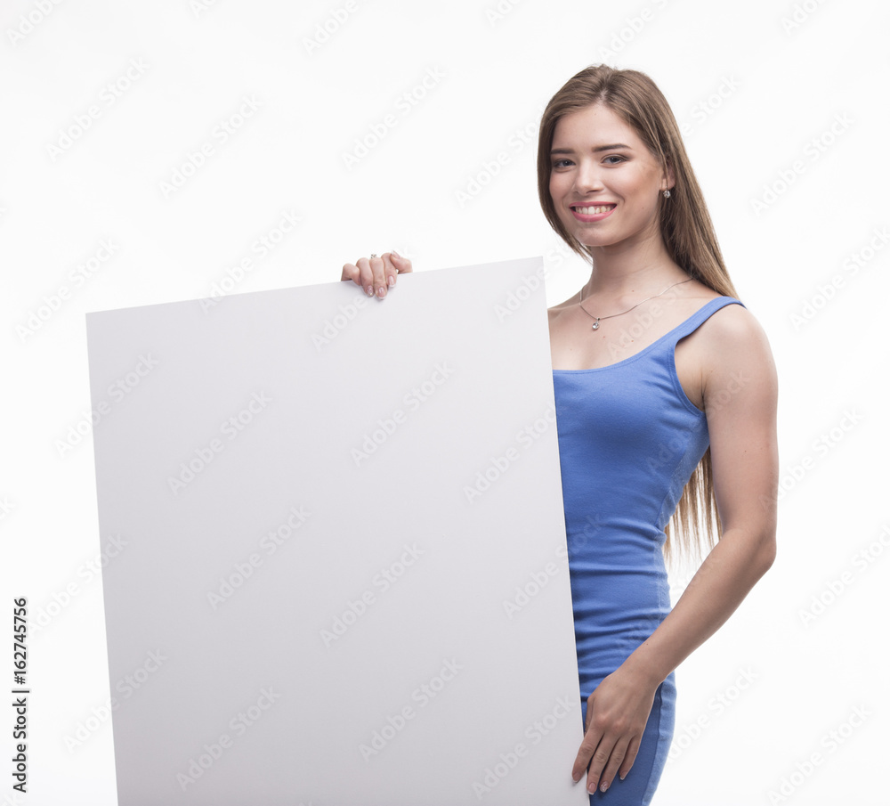Young happy woman portrait of a confident businesswoman showing presentation, pointing paper placard gray background. Ideal for banners, registration forms, presentation, landings, presenting concept. Young happy woman portrait of a confident businesswoman showing presentation, pointing paper placard gray background. Ideal for banners, registration forms, presentation, landings, presenting concept.