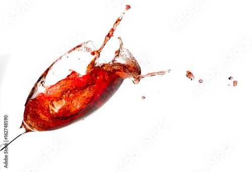 red wine action splash shot glass on white 