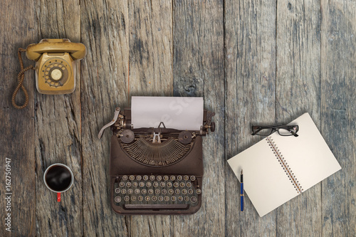 Vintage typewriter and coffee on wood background	