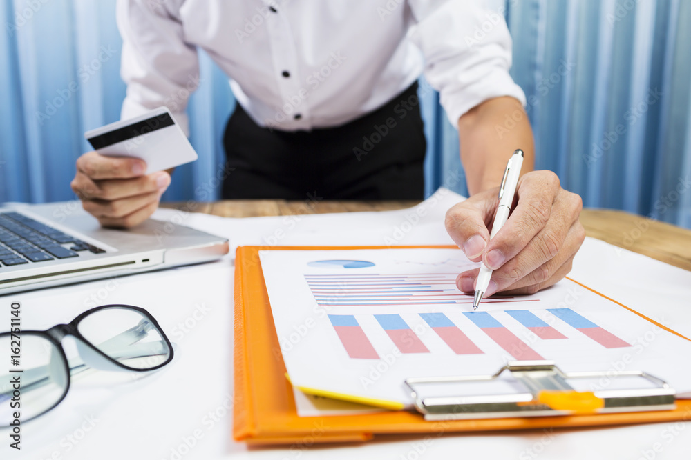 Successful project with business man working hard on financial charts in the office. Successful project with business man working hard on financial charts in the office.