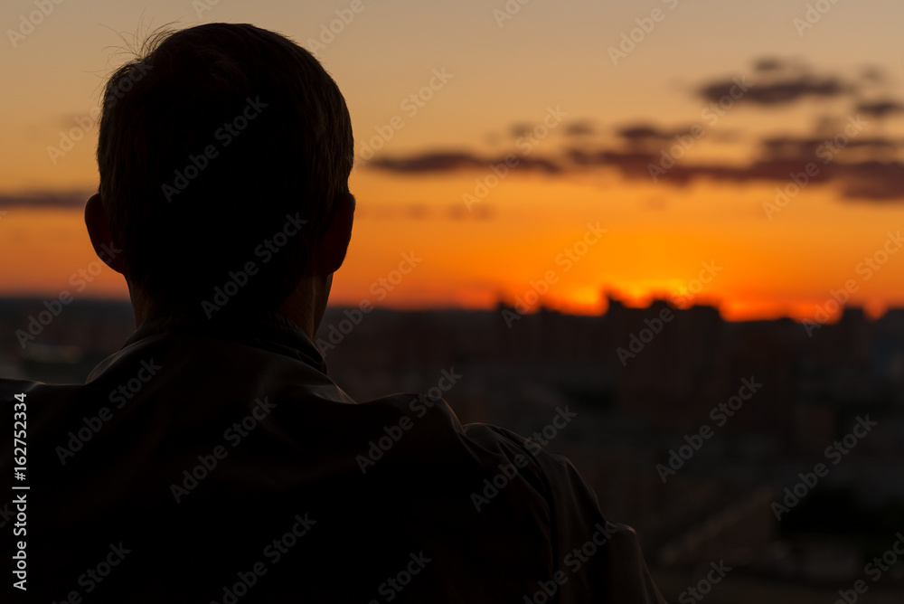 Loneliness. A man admires the setting sun. Khimki. Moscow oblast. Russia Loneliness. A man admires the setting sun. Khimki. Moscow oblast. Russia