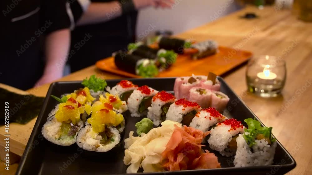 Rotating sushi plate, making sushi in background Rotating sushi plate, making sushi in background