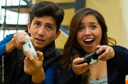 Handsome young man playing video games on the couch, concept about home entertainment, video games photo