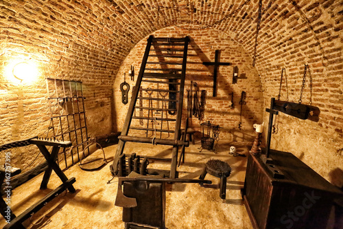 Medieval torture chamber with plenty of tools photo