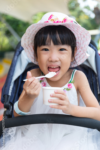 Asian Chinese little girl eating ice cream