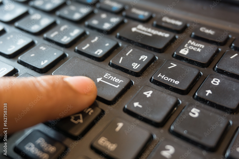 close up women finger point or click on enter button on the thai keyboard close up women finger point or click on enter button on the thai keyboard