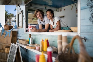 Portrait of waiter and waitress smiling