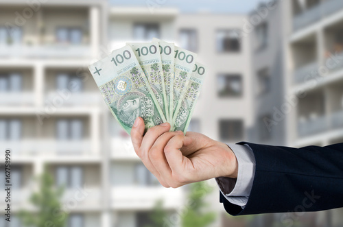 Real estate agent holds Polish money