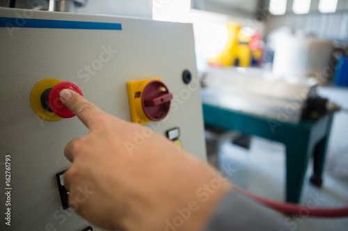 Hand pressing a control button