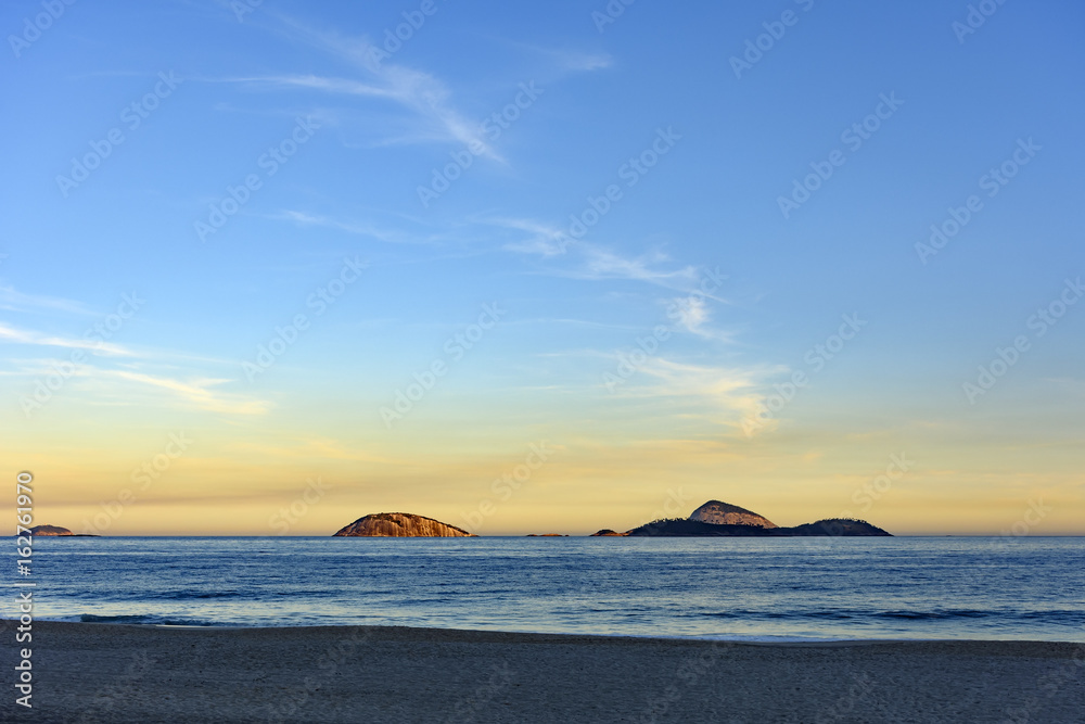 View of Cagarras islands at dusk in front off Ipanema beach in Rio de Janeiro