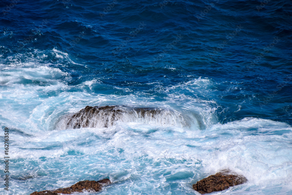Atlantic waves crashing over rocks in the sea Atlantic waves crashing over rocks in the sea