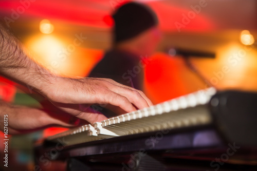 Musician plays keyboards in a rock band