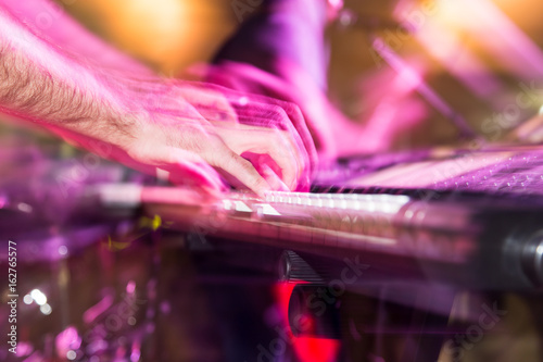 Musician plays keyboards in a rock band